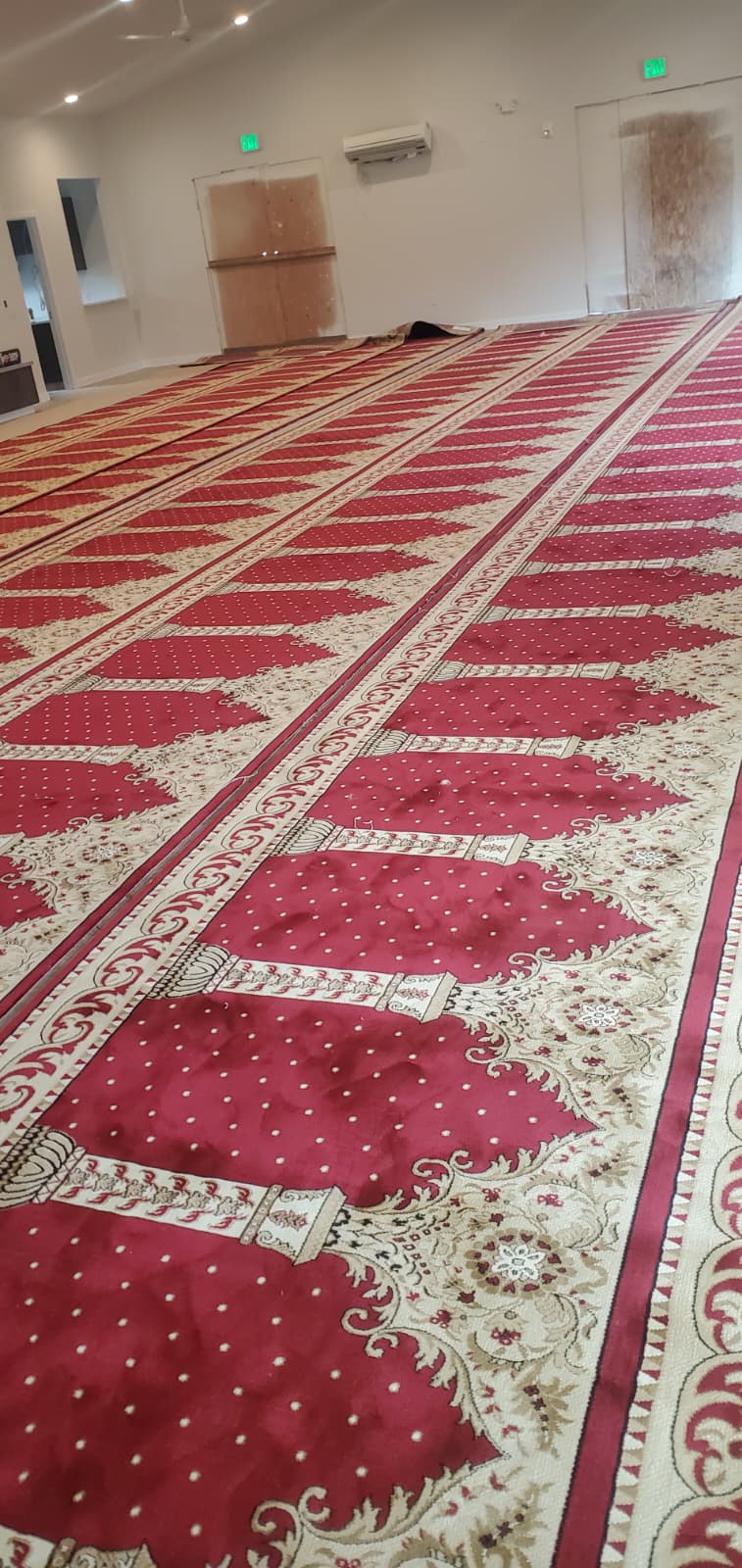 Red patterned carpet across a church interior