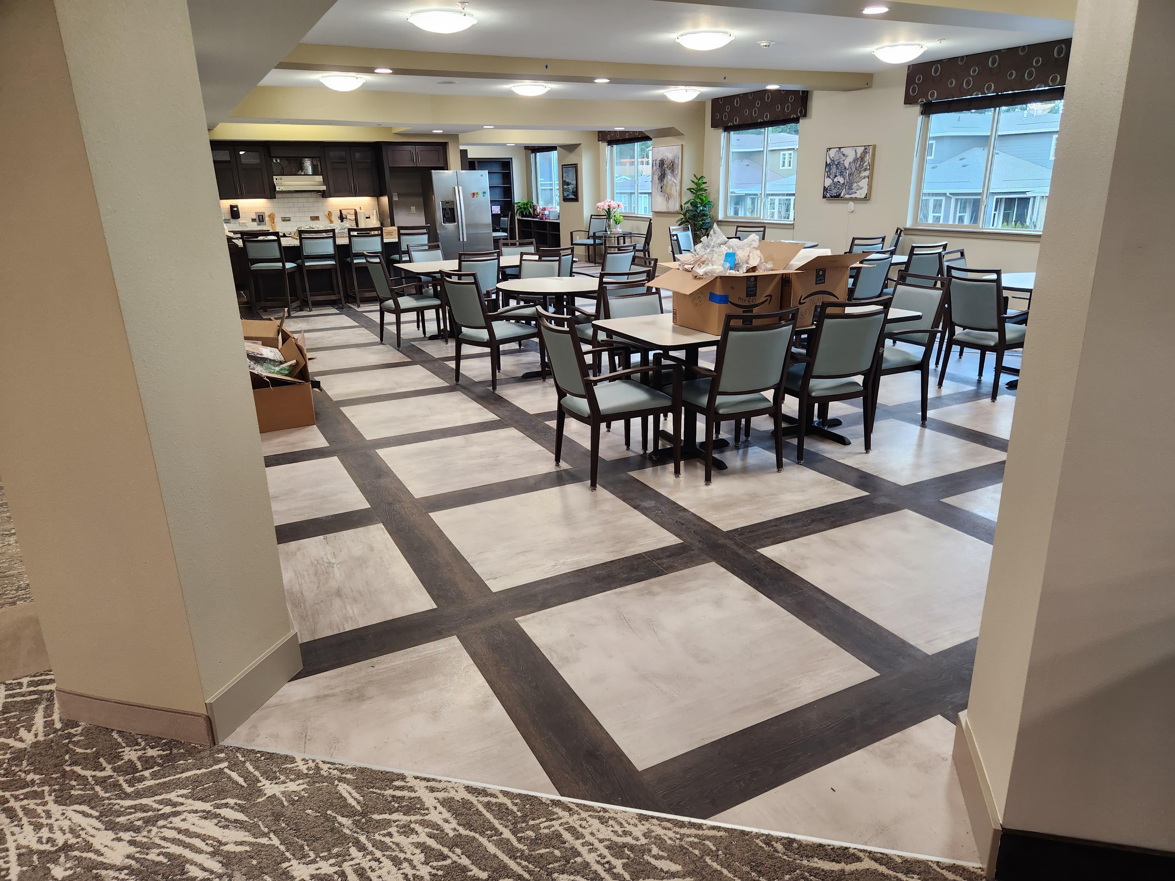 Geometric hard-surface flooring in a community dining space